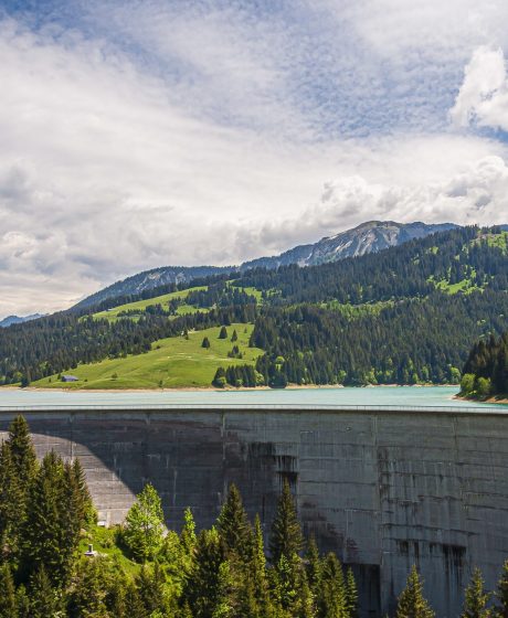 Beautiful shot of Lac de l'Hongrin dam with mountains under a clear sky - perfect for travel blog A beautiful shot of Lac de l'Hongrin dam with mountains under a clear sky - perfect for travel blog